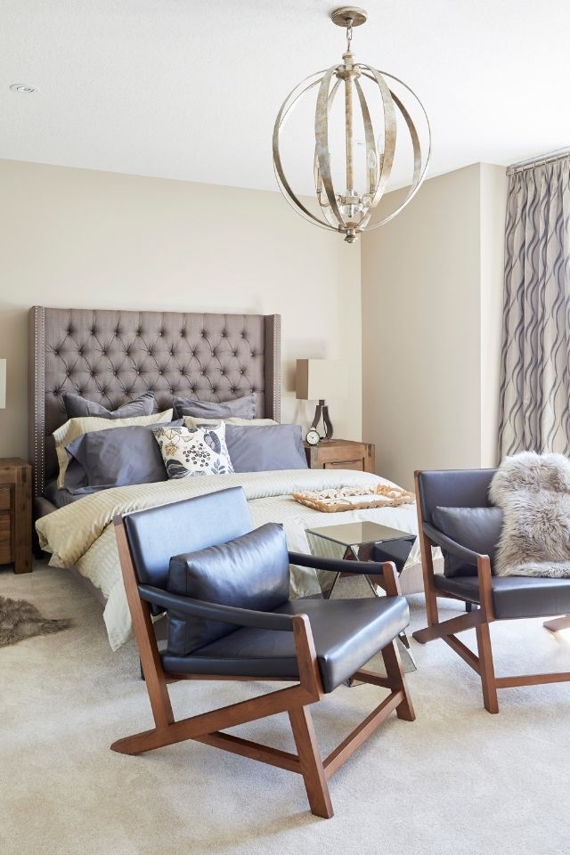Comfortable bedroom with seating area and leather chairs